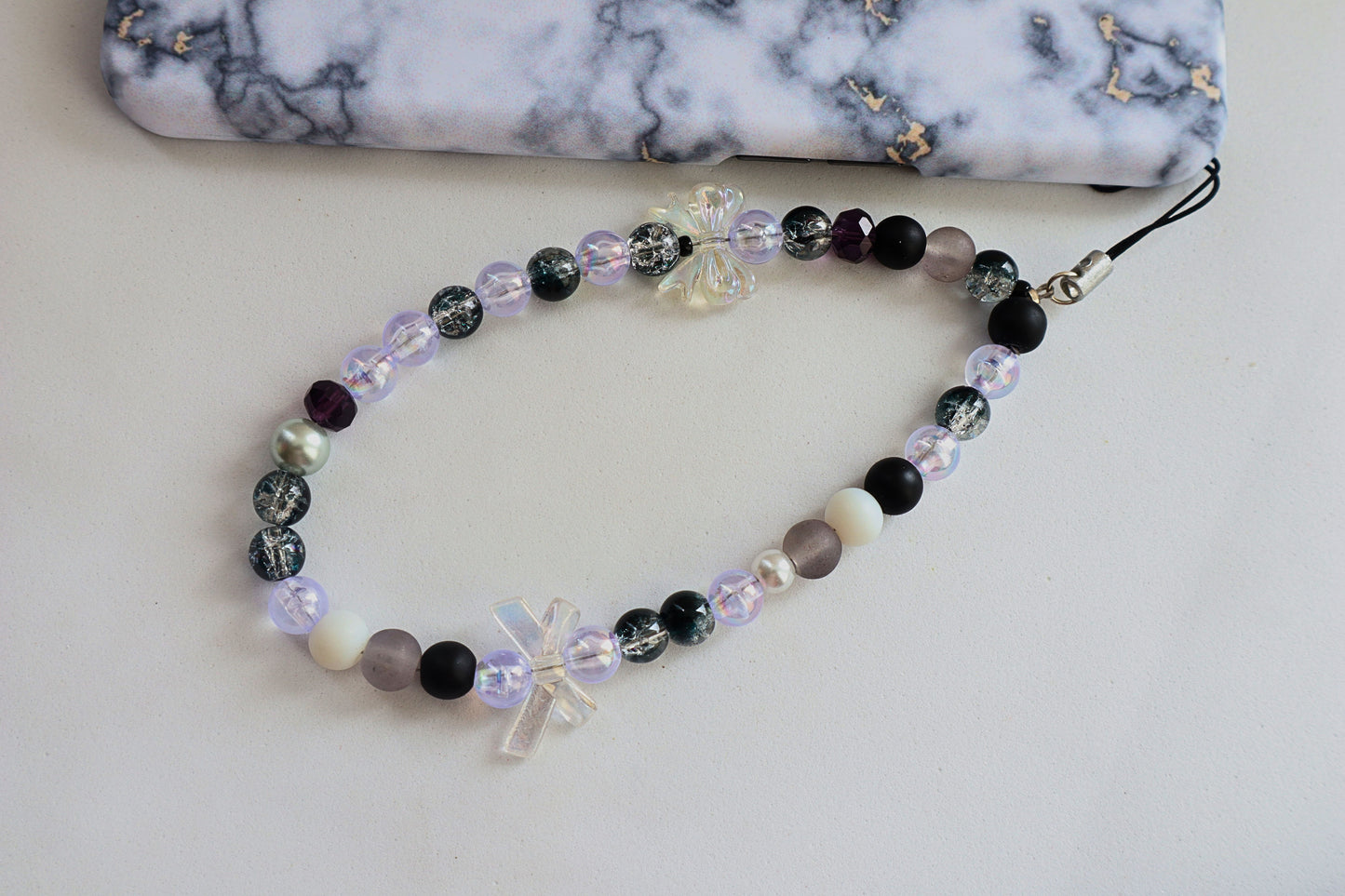 Kamule Glossy black, matte grey, and shimmering pearl beads phone charm
