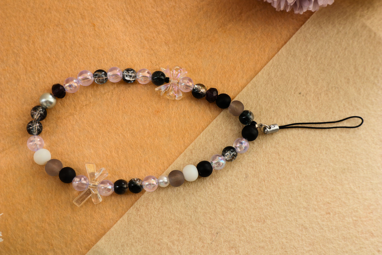 Kamule Glossy black, matte grey, and shimmering pearl beads phone charm