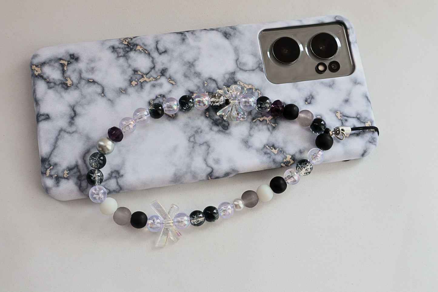 Kamule Glossy black, matte grey, and shimmering pearl beads phone charm