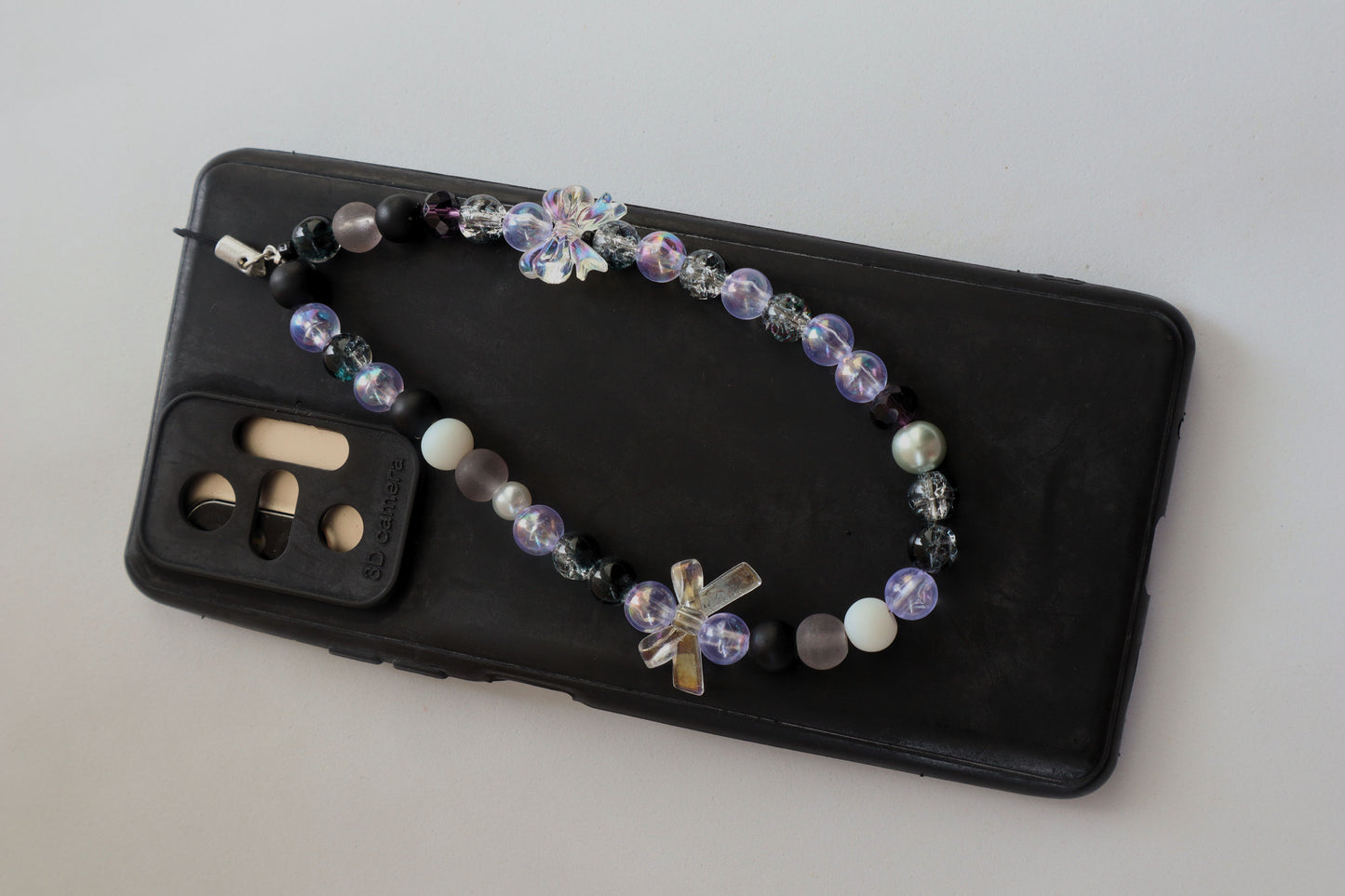 Kamule Glossy black, matte grey, and shimmering pearl beads phone charm