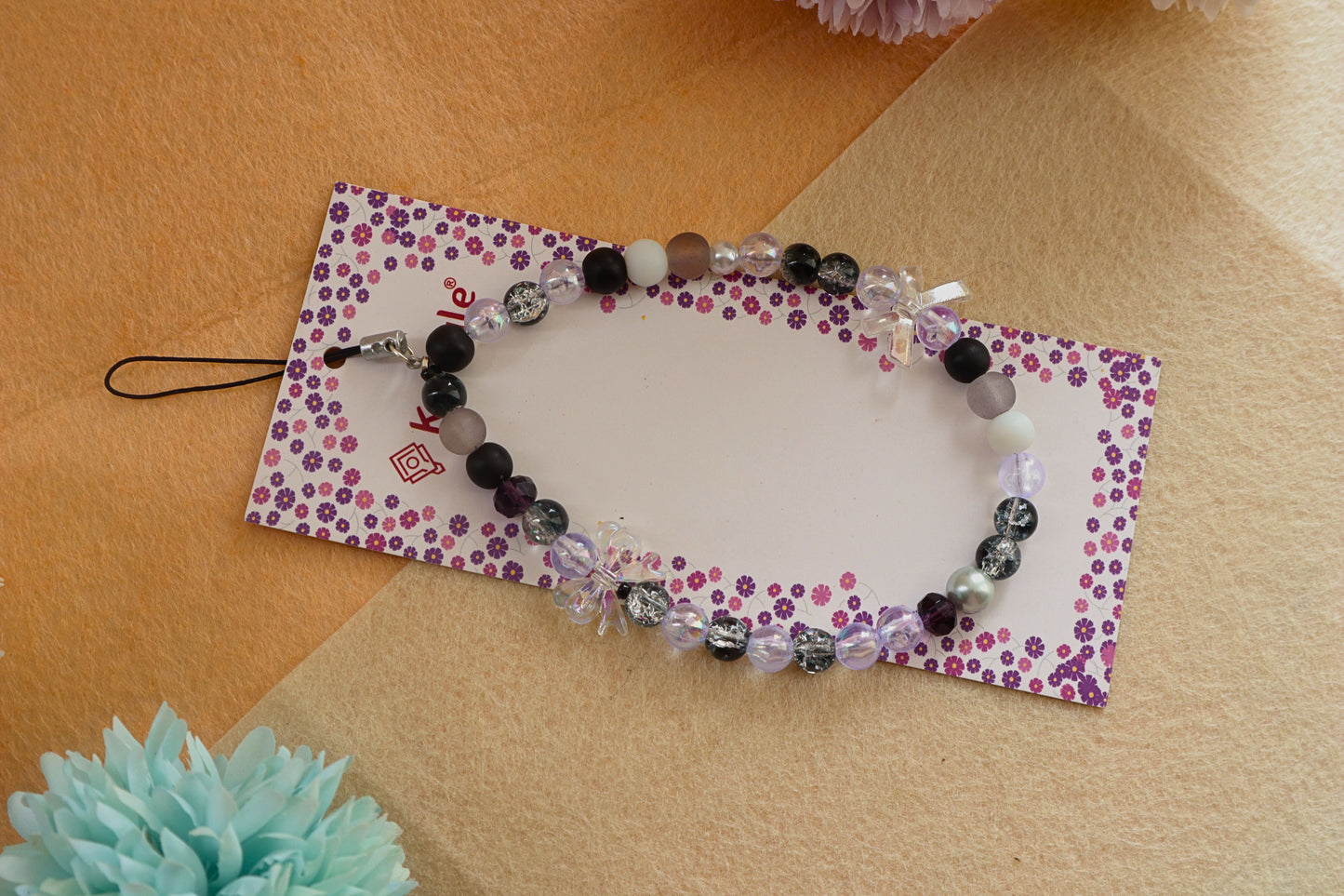 Kamule Glossy black, matte grey, and shimmering pearl beads phone charm