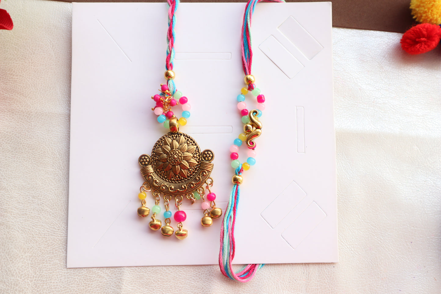 Kamule Ethnic design With Ghungroo Brother Sister Rakhi Set of 2 - Multicolour