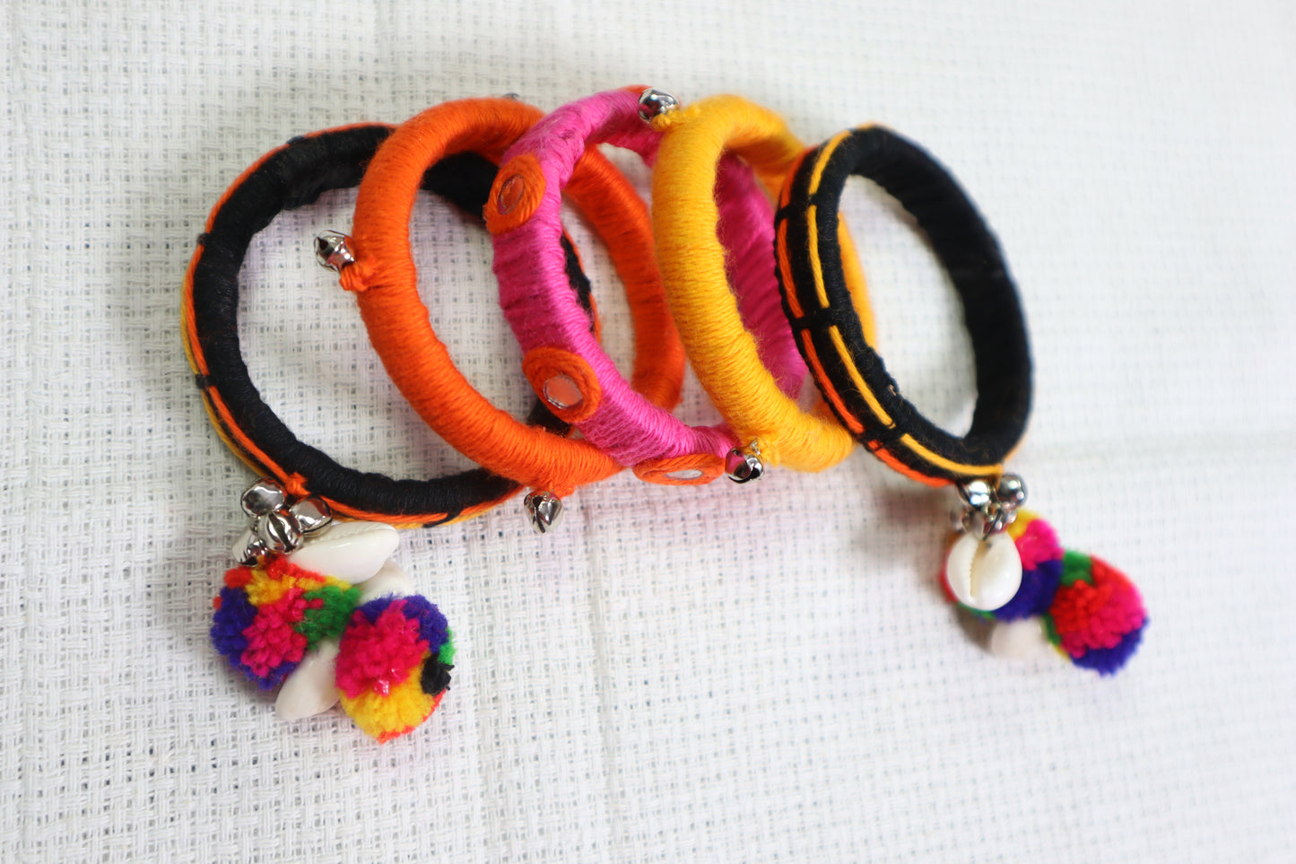 Kamule Navratri-Inspired Set of 5 Wool Thread Bangles with Shell & Pom-Pom Charms – Multicolour