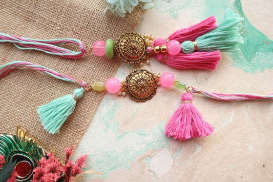 Kamule Oxidized Pendant Embellished Tassel Bhaiya Bhabhi Rakhi Set - Pink and Green